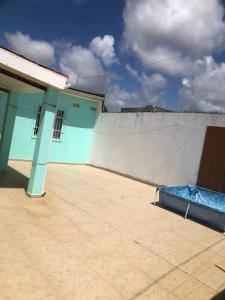 a building with a wall with a mattress on it at Aluguel de quarto com suite in Aracaju