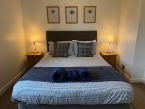 a bedroom with a bed with blue towels on it at Misty Isles View in Portree