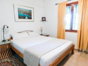 a bedroom with a large white bed and a window at The Windmill, Garden House in Llubí +33 photos