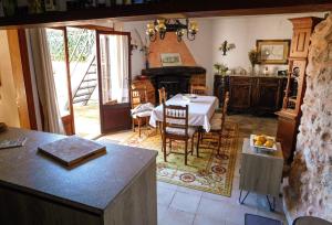 a kitchen with a table and a dining room at The Windmill, Garden House in Llubí