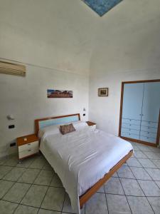 a bedroom with a large bed and a window at Dany House in Atrani