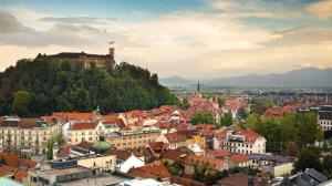 a city with a castle on top of a hill at Rookos rooms in Ljubljana