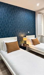 a bedroom with two beds and a blue wall at Velvet Prime Stay in Lisbon +14 photos