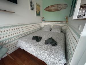 a bed in a room with two pillows on it at Studio Cosy Biarritz - classé 2 étoiles in Biarritz