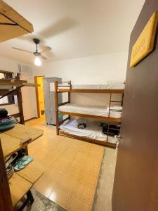 a room with bunk beds on the floor in a room at Cosmopolitans Hostel in Ubatuba