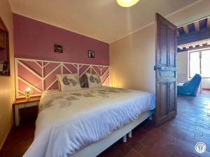 a bedroom with a large bed in a room at Le Refuge in Liernais +15 photos