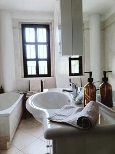 a white bathroom with a tub and a sink at La Casa del Merlo in Rodello +48 photos