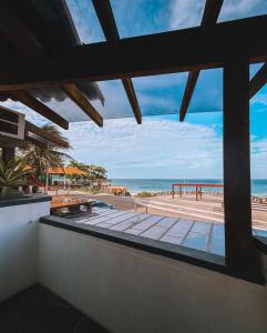 a view of the beach from the balcony of a building at Acuario Pousada in Arraial do Cabo