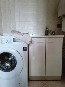 a white washer and dryer in a kitchen at La Casa del Merlo in Rodello