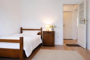 a bedroom with a bed and a table with a lamp at Quiet & Cozy Apartment near Samobor - Terrace, Parking, Close to Zagreb & Tabor in Samobor
