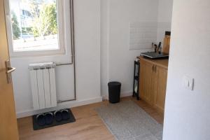 a kitchen with a sink and a window and a door at Quiet & Cozy Apartment near Samobor - Terrace, Parking, Close to Zagreb & Tabor in Samobor
