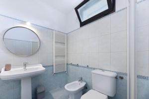 a bathroom with a sink and a toilet and a mirror at Sale Marino - Goelba in Capoliveri +23 photos
