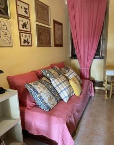 a couch with pillows on it in a room at Lo studio di Gabriella in Bolsena