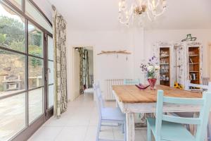 a dining room with a wooden table and blue chairs at Sale Marino - Goelba in Capoliveri