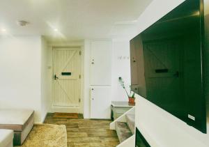 a room with a bed and a door and a hallway at Spacious & Luxury 2BR Flat in Calverton in Calverton