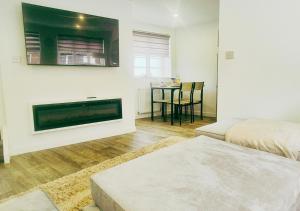 a living room with a fireplace and a table at Spacious & Luxury 2BR Flat in Calverton in Calverton