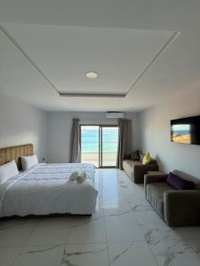 a bedroom with a bed and a couch at Golden Bay Hotel in Al Hoceïma