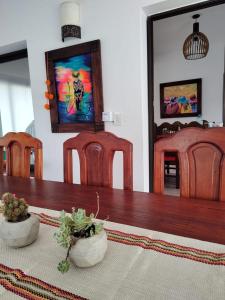 a dining room table with chairs and a painting on the wall at Möller Masi in Purmamarca +31 photos