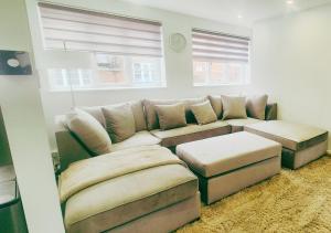 a living room with a couch and ottoman at Spacious & Luxury 2BR Flat in Calverton in Calverton +39 photos