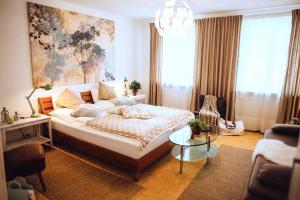 a bedroom with a large bed and a chandelier at DAS STERN - Rooms - Self Check-In in Sankt Gilgen