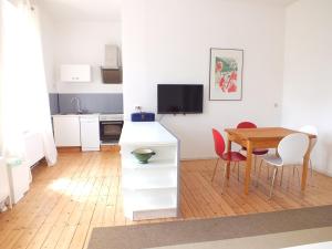 a room with a table and chairs and a kitchen at Rittergut Endorf in Endorf