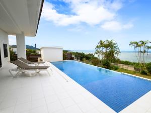 a pool with a view of the ocean from a house at YUTO Ishigakijima in Ishigaki Island