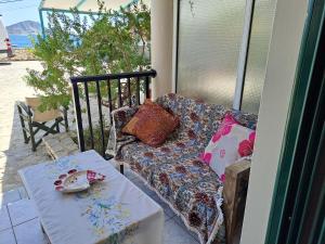 a living room with a couch and a table at Ground floor economy studio in karmiris studios in Zakynthos