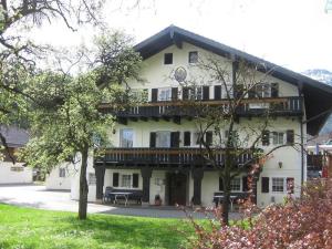 a large white building with a porch and balcony at Pension Lex in Bad Reichenhall