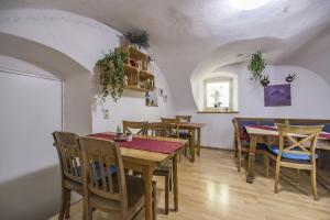 a dining room with wooden tables and chairs at Pension Lex in Bad Reichenhall +42 photos