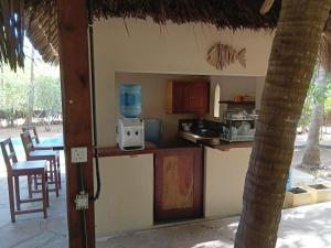 a kitchen with a counter and a table and chairs at Marlin room in Watamu +3 photos