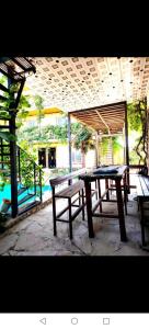 a picnic table and benches under a pavilion at Baku "ISR" Guest House in Sǝnqǝçal Stansiyası