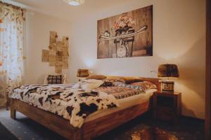 a bedroom with a bed with a cow blanket at DAS STERN - Rooms - Self Check-In in Sankt Gilgen