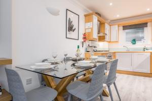 a kitchen with a dining room table and chairs at Magnolia House - Beautiful Townhouse in Old Town Poole in Poole