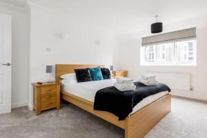 a bedroom with a large bed and a window at Magnolia House - Beautiful Townhouse in Old Town Poole in Poole