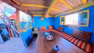 a living room with a couch in a bus at Surfaces Hostel in Taghazout