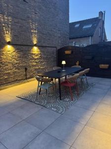 a black table and chairs on a patio at BLESS Valkenburg in Valkenburg