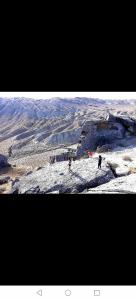 two people standing on top of a snow covered mountain at Baku "ISR" Guest House in Sǝnqǝçal Stansiyası