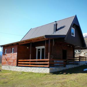 a log cabin with a gambrel roof at Mountain House Jelovica in Berane