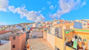 a view of a city with colorful buildings at Surfaces Hostel in Taghazout