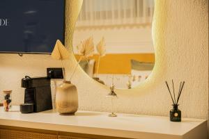 a counter with a mirror and vases on it at Lyse Jülide Hotel in Çeşme