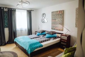 a bedroom with a large bed with blue pillows at DAS STERN - Rooms - Self Check-In in Sankt Gilgen +14 photos