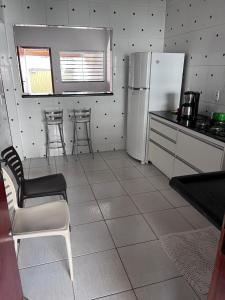 a kitchen with a refrigerator and a table and chairs at Casa jardim fonte nova in Goiânia +13 photos