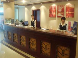 two women standing at a counter in a store at GreenTree Inn Ji‘nan Shanda Road Business Hotel in Jinan