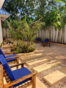 a patio with chairs and plants and a fence at Kendwa Sky Hotel in Kendwa