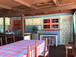 a kitchen with a table and a dining room at Italian Guesthouse in Gros Islet