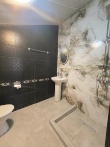 a bathroom with a sink and a toilet and a shower at Hirmas boutique hotel in Tbilisi City +85 photos