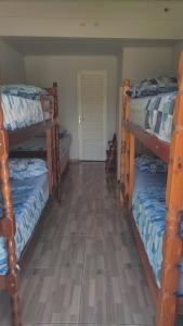 a room with three bunk beds and a hallway at Complete Chácara Pool, WiFi 5min Thermas in São Pedro +28 photos