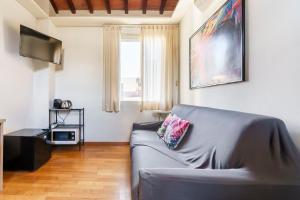 a living room with a couch and a television at Corso Double in Florence +13 photos