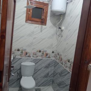 a bathroom with a toilet and a sink at Dakhly siwa in Siwa