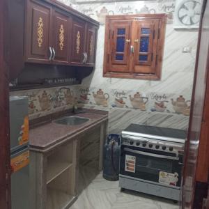 a kitchen with a sink and a stove at Dakhly siwa in Siwa